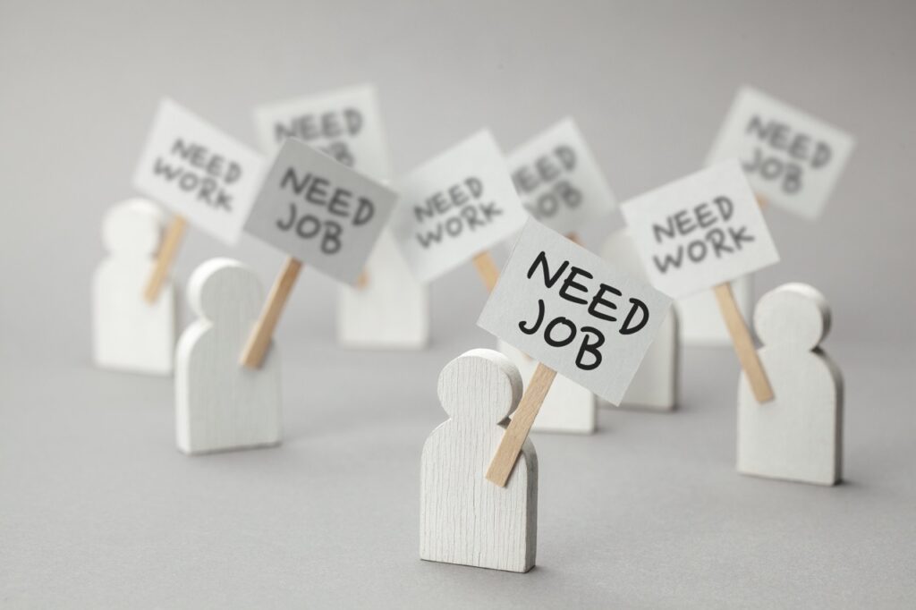 Need Job. Crowd of unemployed people with posters on gray background